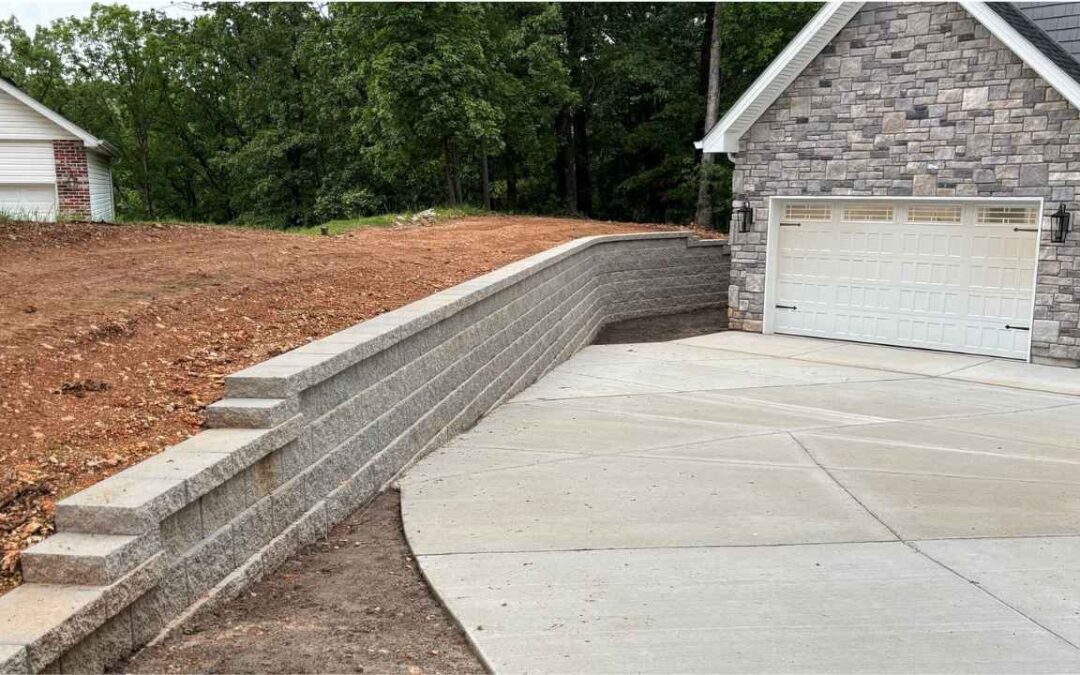 Completed retaining wall and driveway by Retaining Wall & Paving Solutions during fall construction season in St. Louis residential property.