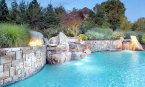 Natural stone retaining wall beside a luxury pool in Missouri