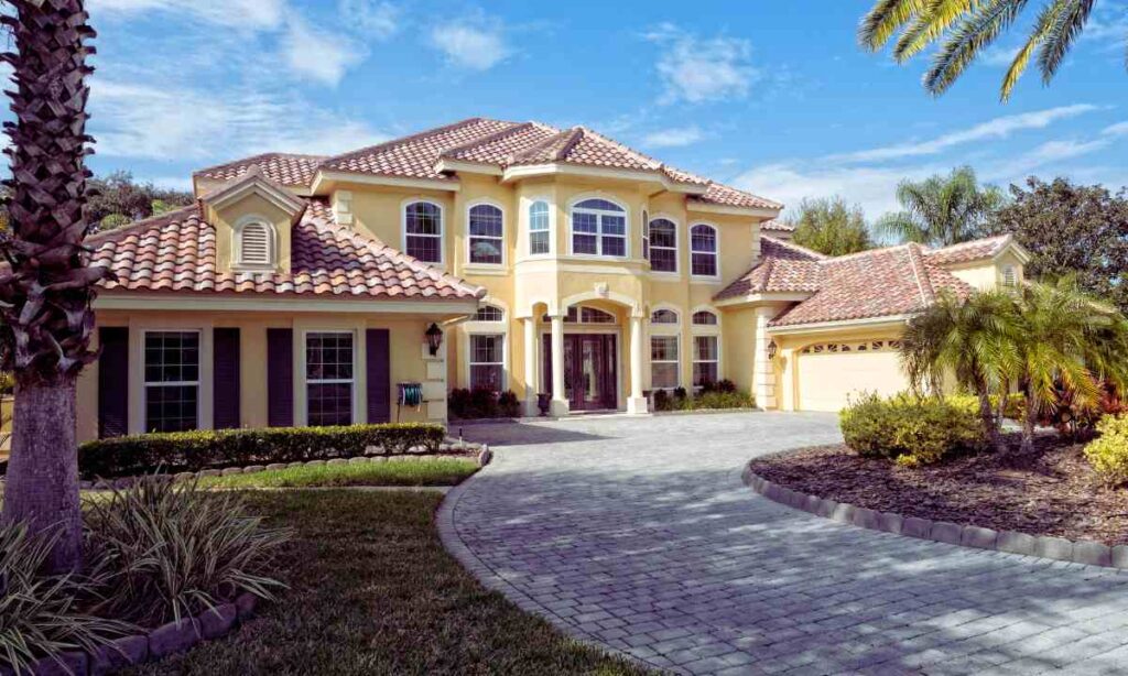 Luxury home with a well-installed paver driveway showing no cracks or shifting—an example of proper base prep and drainage design that prevents damage from expansive clay soil in St. Louis.