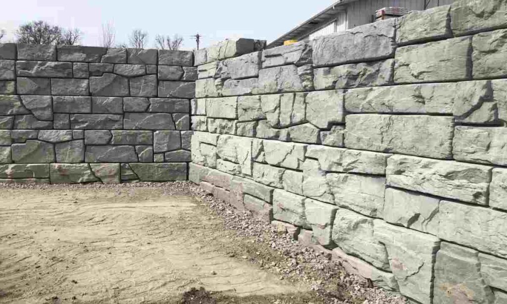 large stone retaining wall blocks showing structural construction and base preparation